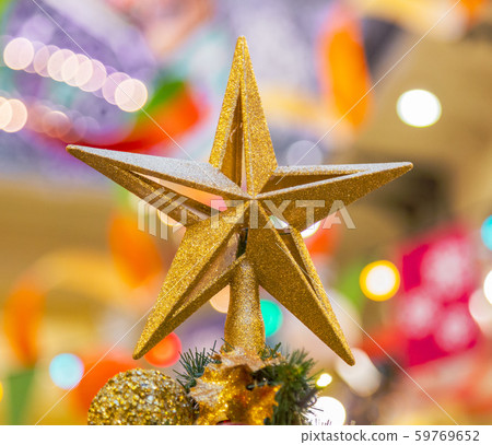 A Christmas decorative - star on the top of A Christmas tree with a beautiful bokeh background 59769652