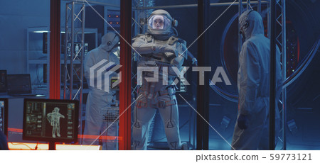 American astronaut testing spacesuit mobility 59773121