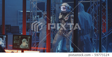 American astronaut testing spacesuit mobility 59773124