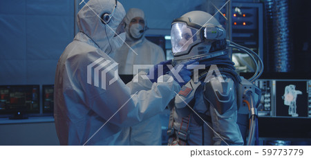 Astronaut and scientists testing spacesuit Astronaut and scientists testing spacesuit 59773779