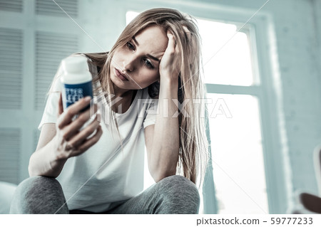 Depressed nice young woman holding her hair Depressed nice young woman holding her hair 59777233