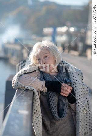 Poor homeless woman having no food but drinking hot tea Poor homeless woman having no food but drinking hot tea 59777540