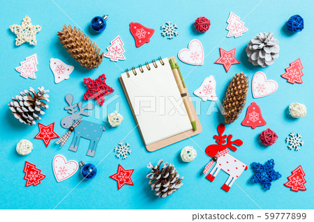 Top view of notebook surrounded with New Year toys Top view of notebook surrounded with New Year toys 59777899