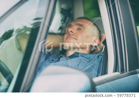 Man sleeping in the car 59778371