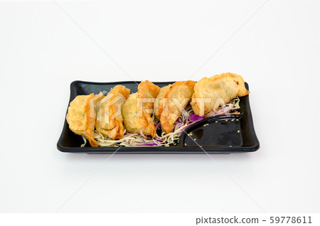 Deep fried pork Dumplings with soy sauce on plate Deep fried pork Dumplings with soy sauce on plate 59778611