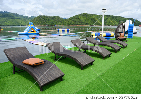 Modern black loungers on artificial lawn on 59778612