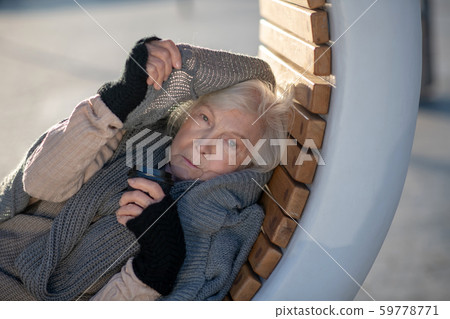 Poor aged woman feeling very cold outside Poor aged woman feeling very cold outside 59778771