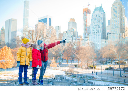 Family of father and kids in Central Park during their vacation in New York City Family of father and kids in Central Park during their vacation in New York City 59779172
