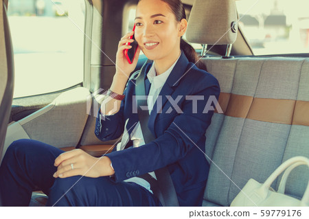 Positive delighted brunette female talking per telephone Positive delighted brunette female talking per telephone 59779176