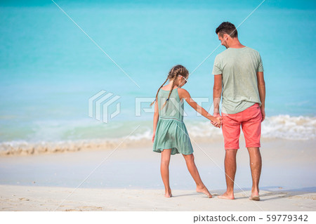 Little girl and happy dad having fun during beach vacation Little girl and happy dad having fun during beach vacation 59779342