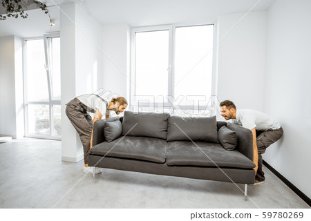 Movers placing couch at home Movers placing couch at home 59780269