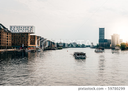 Scenic view of Spree River and Berlin cityscape from Oberbaum Bridge. Sun flare on background Scenic view of Spree River and Berlin cityscape from Oberbaum Bridge. Sun flare on background 59780299
