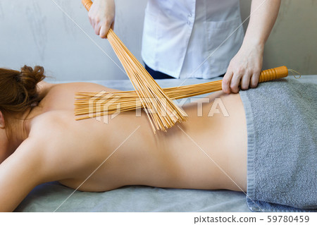 Back massage in the massage room with bamboo 59780459