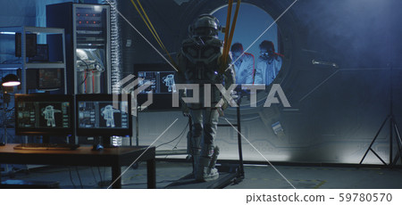 Astronaut walking on a treadmill 59780570