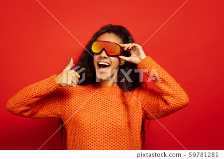 African-american young woman's portrait in ski mask on red background 59781281