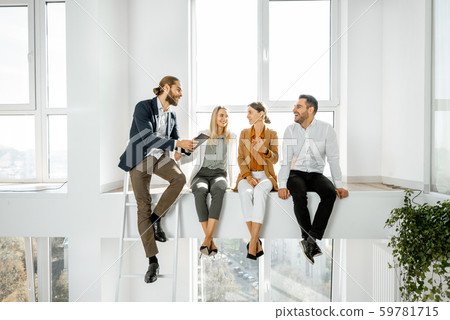 Office employees having informal discussion in the meeting room Office employees having informal discussion in the meeting room 59781715