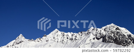 Snowy mountains and blue clear sky at sun day Snowy mountains and blue clear sky at sun day 59782292