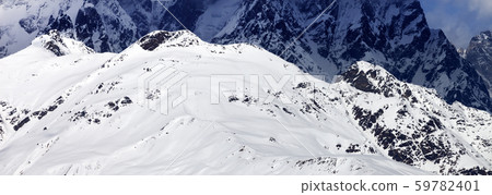 Panoramic view on sunlit snowy mountains at winter Panoramic view on sunlit snowy mountains at winter 59782401