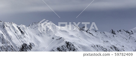 High snowy mountains and sunlight storm sky before High snowy mountains and sunlight storm sky before 59782409
