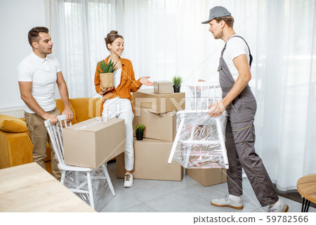 Young couple moving into a new house Young couple moving into a new house 59782566