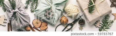 Fabric wrapped gifts and wooden Christmas decorations 59783767