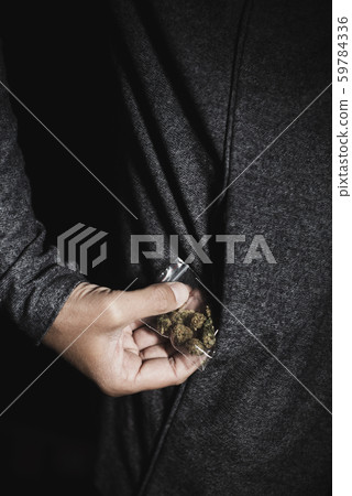 young man with a bag of marihuana buds young man with a bag of marihuana buds 59784336