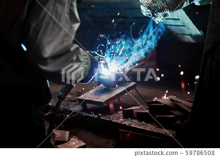 Industrial factory weld worker. Welding or welder master weld the steel 59786508