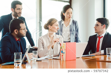 Legal In-house team working in the office on a project 59787342