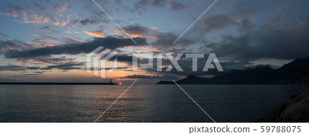 lighthouse at sunset and magnificent sky with textured clouds lighthouse at sunset and magnificent sky with textured clouds 59788075