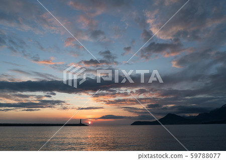 lighthouse at sunset and magnificent sky with textured clouds lighthouse at sunset and magnificent sky with textured clouds 59788077