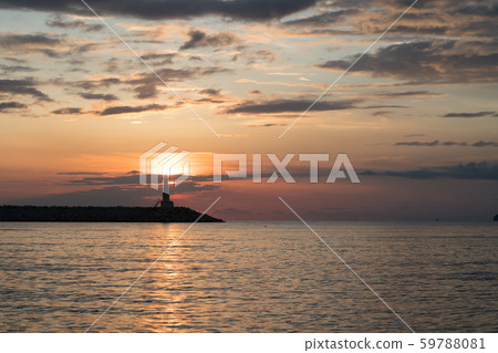 lighthouse at sunset and magnificent sky with textured clouds 59788081
