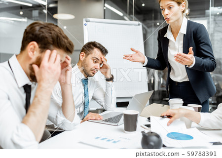 Boss quarreling at employees during a conference Boss quarreling at employees during a conference 59788391