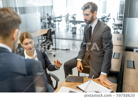 Business people during a discussion at the working place Business people during a discussion at the working place 59788620