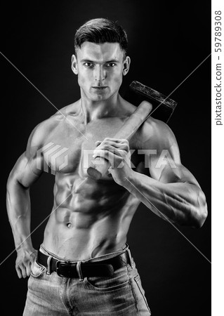 Muscular man with naked torso holding big hummer. Isolated on dark grey background Muscular man with naked torso holding big hummer. Isolated on dark grey background 59789308