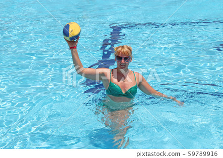 Fashionable woman with ball for rugby swimming in 59789916
