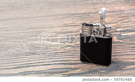 Cigarette lighter on a wooden 59791489