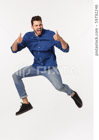 Portrait of a satisfied young caucasian man celebrating success isolated over white background. Portrait of a satisfied young caucasian man celebrating success isolated over white background. 59792246