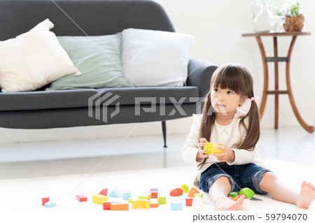 Girl playing with building blocks 59794070
