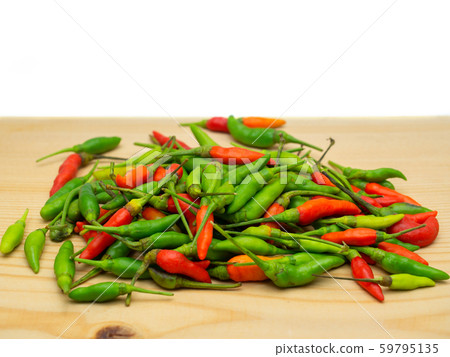 Red and Green hot chilli on a wooden floor. 59795135