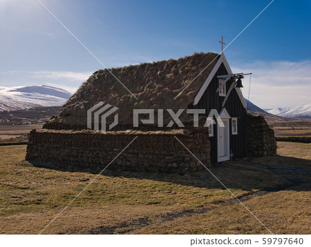 Peat church in Iceland with a bell above the door 59797640