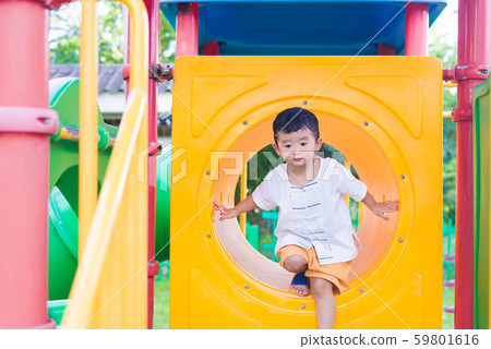 Cute Asian boy playing and smiling in yellow Cute Asian boy playing and smiling in yellow 59801616