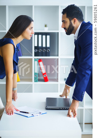 Portrait of angry people looking at each other during conflict Portrait of angry people looking at each other during conflict 59805261