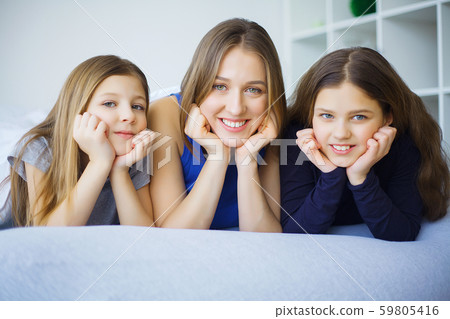 Mother and daughter enjoy in bed at home 59805416