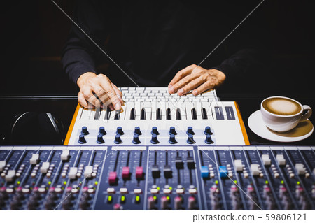 male musician hands playing midi keyboard for recording music on computer in home recording studio. music production concept 59806121