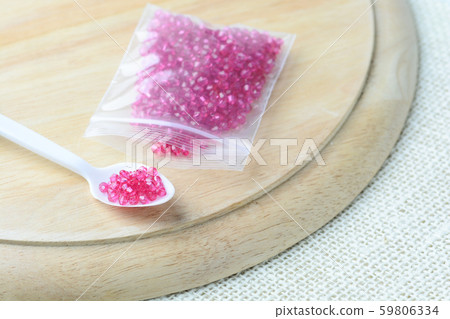 Colorful beads on a wooden surface. Various of Colorful beads on a wooden surface. Various of 59806334