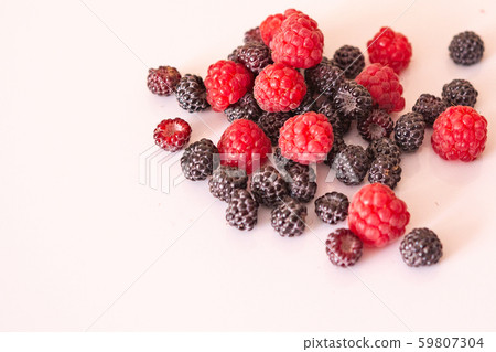 Black and red raspberry composition on a white Black and red raspberry composition on a white 59807304