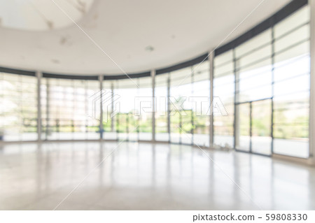 Blur background interior view looking out toward to empty office lobby and entrance doors and glass curtain wall 59808330