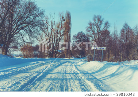 Snowy country road in winter sunny day Snowy country road in winter sunny day 59810348