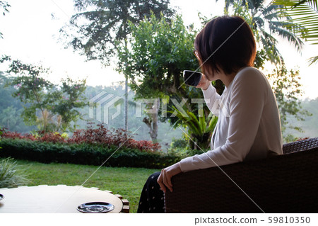 A beautiful young woman drnking tea and relaxing in the morning A beautiful young woman drnking tea and relaxing in the morning 59810350