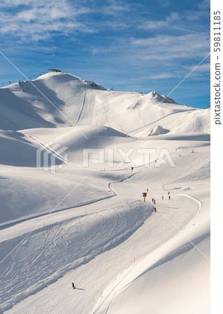 Scenic valley of hilghland alpine mountain winter resort on bright sunny day. Wintersport scene with Scenic valley of hilghland alpine mountain winter resort on bright sunny day. Wintersport scene with 59811185